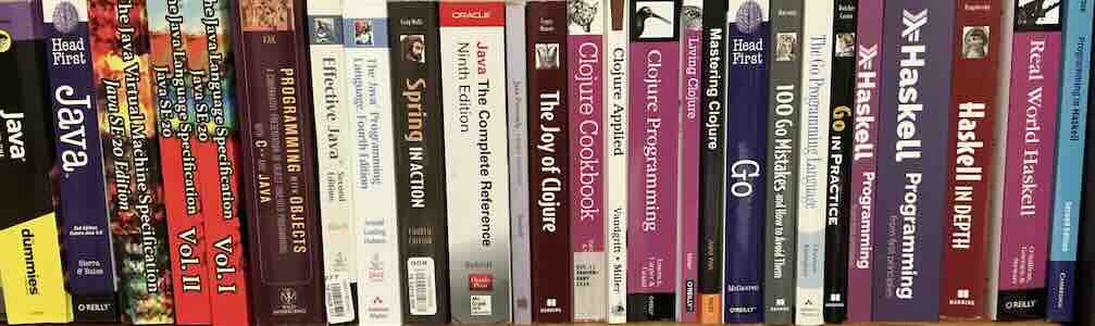 A collection on books about programming. Subjects from left to right: Java, Clojure, Go, and Haskell